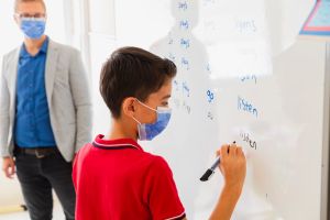 Elementary school children are learning english in classroom